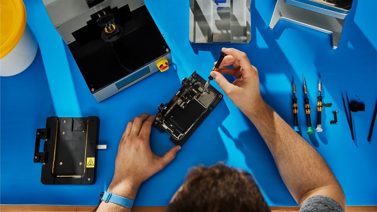iPhone repair technician working on device